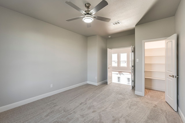 unfurnished bedroom with light colored carpet, visible vents, and baseboards