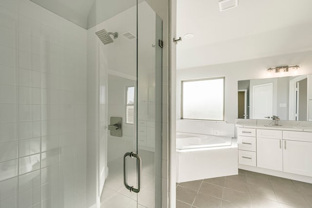 bathroom with a garden tub, a shower stall, visible vents, and tile patterned flooring