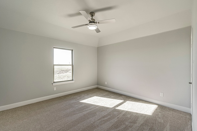 spare room with carpet, baseboards, and a ceiling fan