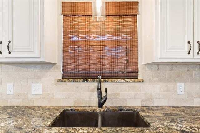 806 N College Ave, West, TX 76691 - kitchen featuring tasteful backsplash, dark stone countertops, a sink, and white cabinetry