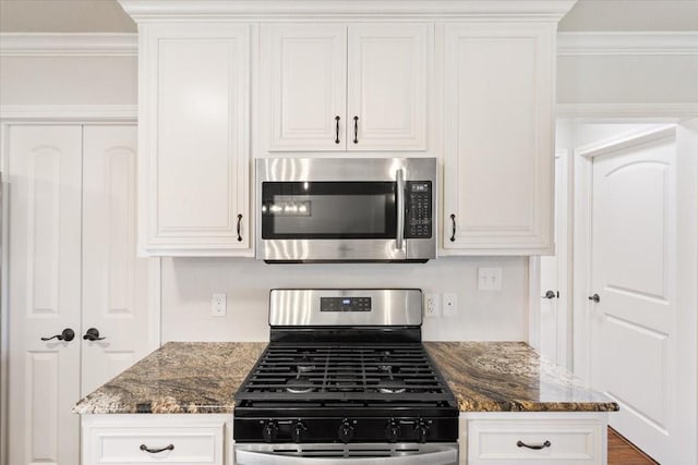 806 N College Ave, West, TX 76691 - kitchen with appliances with stainless steel finishes, white cabinetry, and crown molding