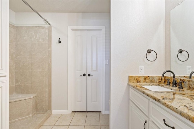 806 N College Ave, West, TX 76691 - full bath featuring tile patterned flooring, a tile shower, vanity, and baseboards