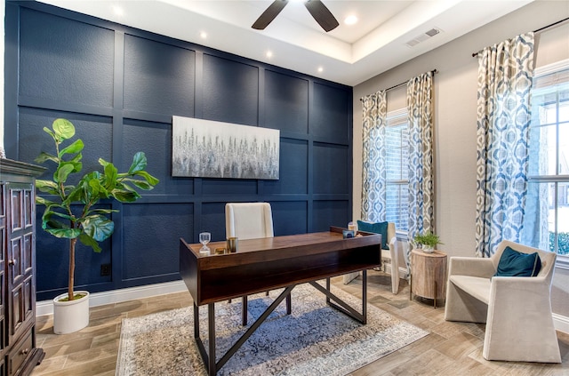 office space with light wood-style flooring, recessed lighting, a decorative wall, a ceiling fan, and visible vents