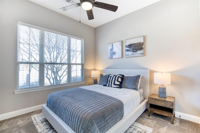 carpeted bedroom with baseboards and a ceiling fan