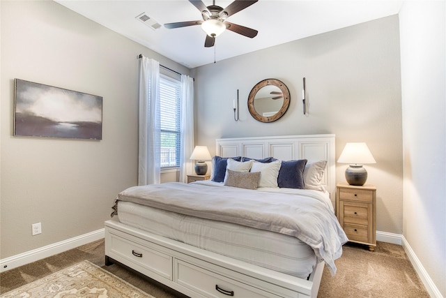 bedroom featuring a ceiling fan, light colored carpet, visible vents, and baseboards