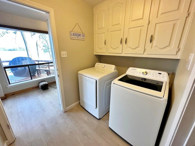 clothes washing area with light wood-type flooring, independent washer and dryer, cabinet space, and baseboards