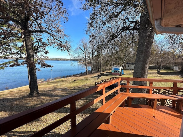 wooden deck featuring a yard and a water view