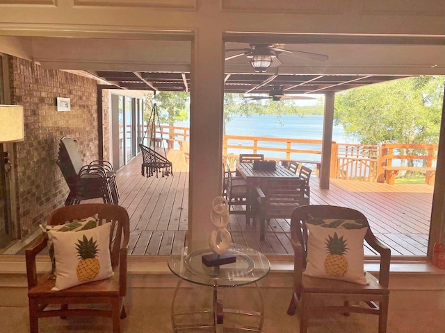 deck featuring a water view and ceiling fan