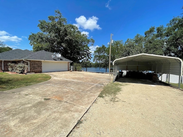 view of side of home with a garage, concrete driveway, brick siding, and a lawn