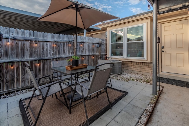 view of patio / terrace with outdoor dining space and fence