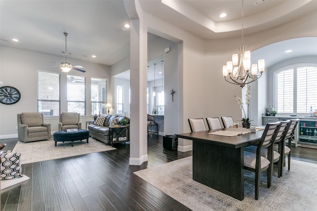 dining space with dark wood-style flooring, recessed lighting, a raised ceiling, visible vents, and baseboards