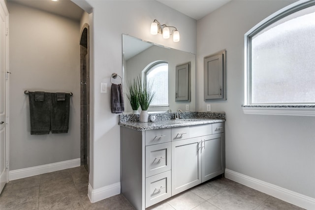 full bathroom featuring tile patterned floors, vanity, and baseboards