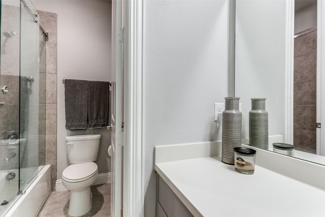 full bath featuring shower / bath combination with glass door, vanity, toilet, and tile patterned floors