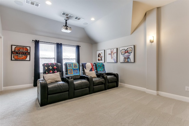 home theater room with light colored carpet, visible vents, and lofted ceiling