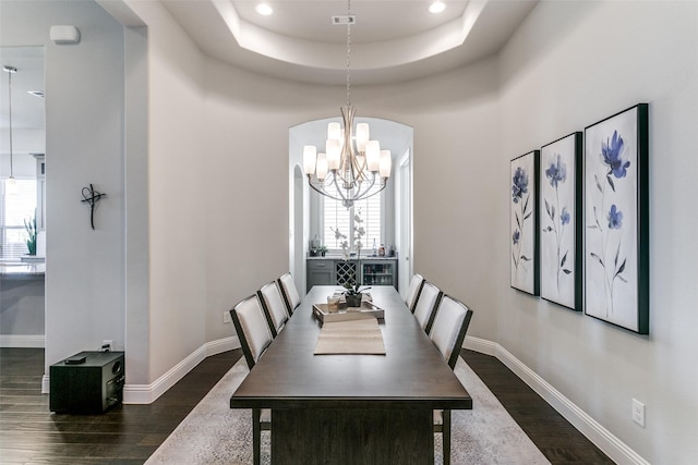 dining room featuring a healthy amount of sunlight, baseboards, and dark wood finished floors