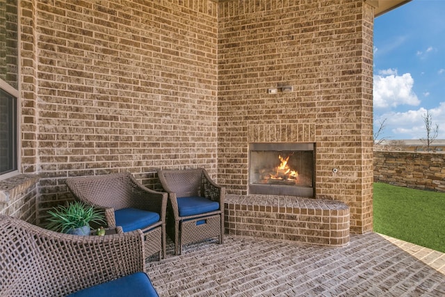 view of patio / terrace featuring an outdoor brick fireplace