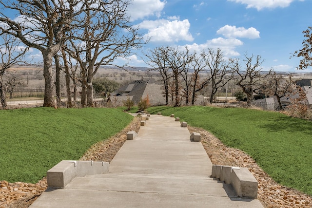 view of property's community with a yard