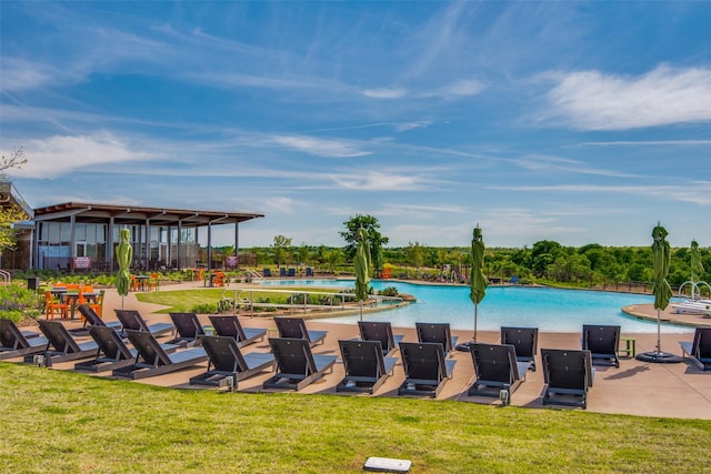 community pool featuring a patio area and a yard