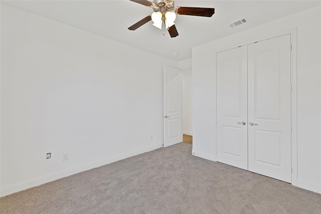 unfurnished bedroom featuring baseboards, visible vents, a ceiling fan, carpet flooring, and a closet