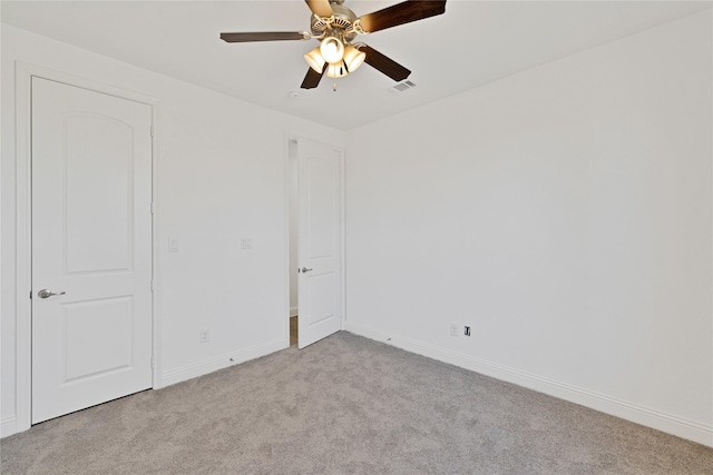 unfurnished room featuring baseboards, visible vents, ceiling fan, and carpet flooring