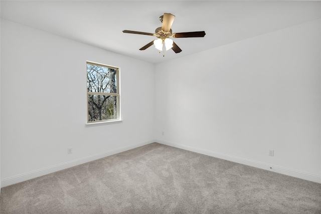 empty room featuring ceiling fan, carpet, and baseboards