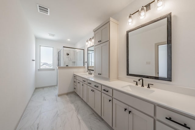 full bath with marble finish floor, a shower stall, visible vents, and a sink