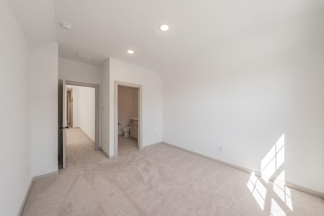 unfurnished bedroom featuring light carpet, baseboards, and recessed lighting