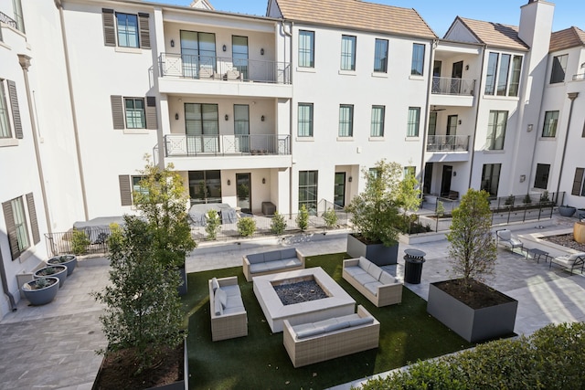 exterior space featuring a fire pit and stucco siding