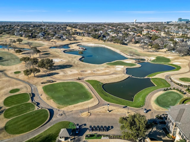 aerial view with golf course view and a water view