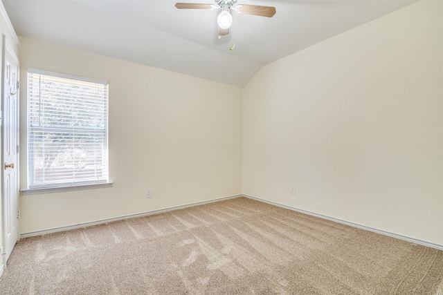 unfurnished room featuring light carpet, baseboards, a ceiling fan, and lofted ceiling