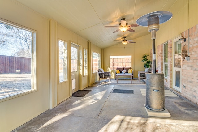 sunroom featuring vaulted ceiling and a ceiling fan