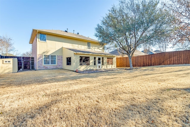 back of house with a yard and fence