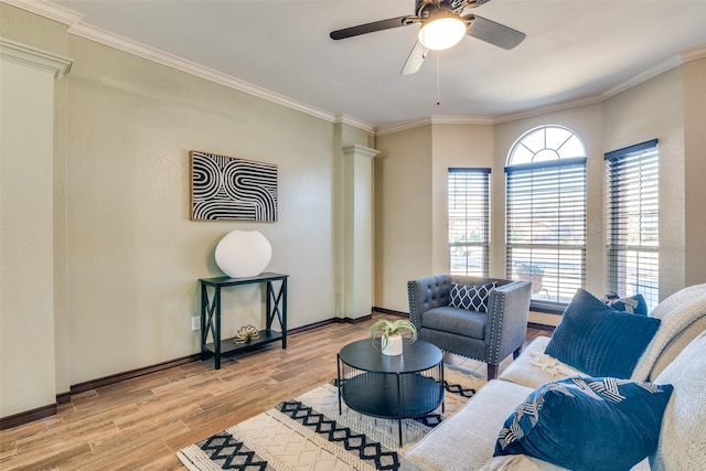 living area featuring light wood-type flooring, baseboards, and ornamental molding