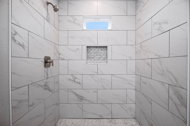 bathroom with tiled shower