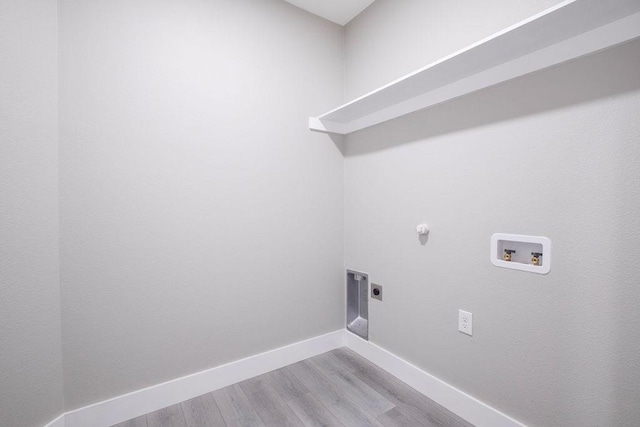 laundry area featuring hookup for a washing machine, laundry area, baseboards, light wood-style floors, and electric dryer hookup