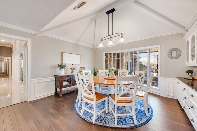 dining space featuring dark wood-style flooring, visible vents, a wainscoted wall, and lofted ceiling with beams