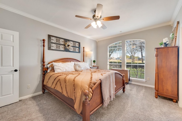 carpeted bedroom with ornamental molding, a ceiling fan, and baseboards