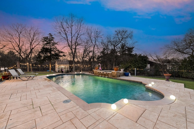 view of swimming pool featuring a patio area, a hot tub, fence, and a fenced in pool