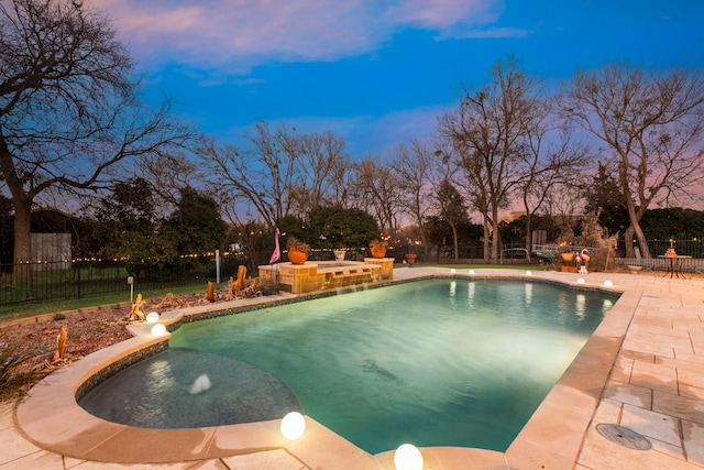 pool at dusk featuring a hot tub, a patio area, a fenced backyard, and a fenced in pool