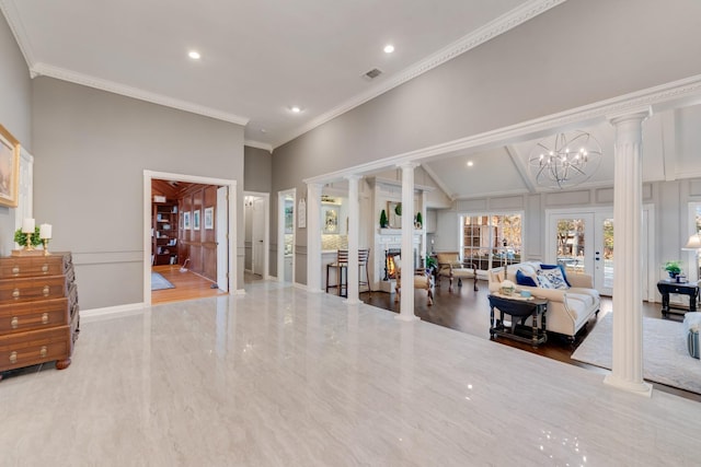 living area with a warm lit fireplace, decorative columns, crown molding, and french doors