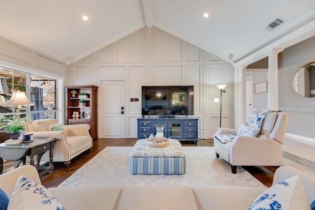 living room with decorative columns, visible vents, dark wood finished floors, vaulted ceiling with beams, and a decorative wall