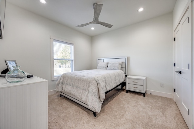 bedroom with a ceiling fan, recessed lighting, light colored carpet, and baseboards