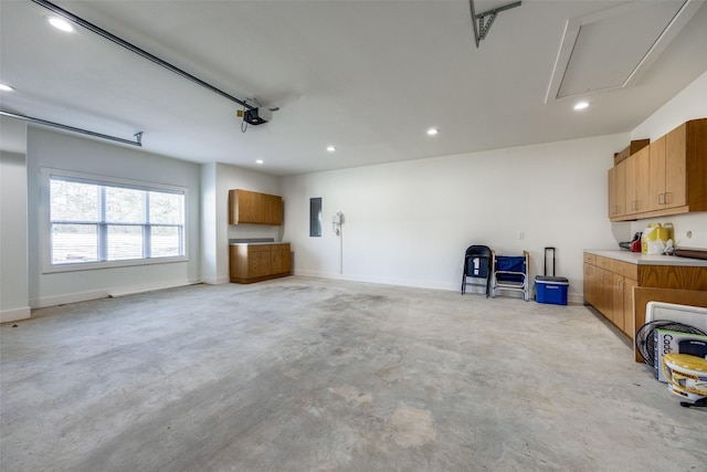 garage with recessed lighting, electric panel, baseboards, and a garage door opener