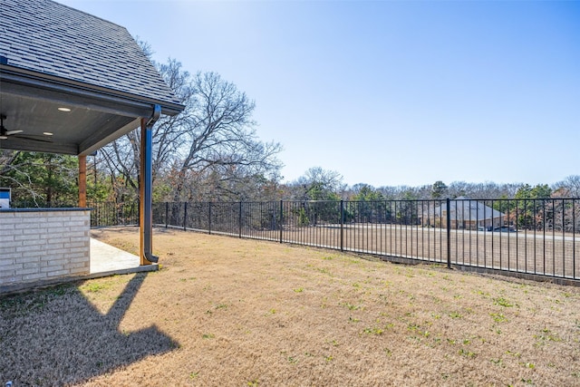 view of yard with a patio, a fenced backyard, and a ceiling fan