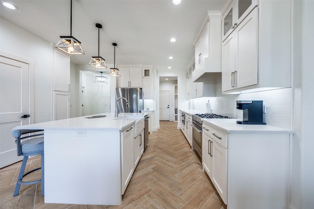 kitchen with recessed lighting, light countertops, decorative backsplash, appliances with stainless steel finishes, and white cabinets