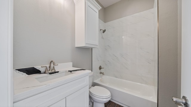 bathroom featuring toilet, tub / shower combination, and vanity