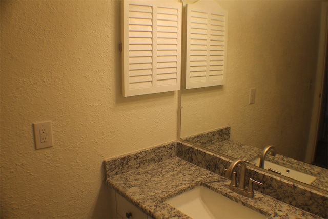 4859 Cedar Springs Rd Unit 147, Dallas, TX 75219 - bathroom featuring a textured wall and vanity