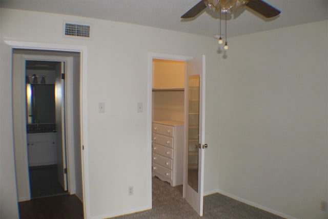 4859 Cedar Springs Rd Unit 147, Dallas, TX 75219 - unfurnished bedroom with carpet floors, visible vents, a spacious closet, a sink, and baseboards