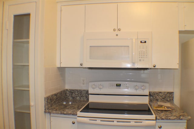 4859 Cedar Springs Rd Unit 147, Dallas, TX 75219 - kitchen featuring white appliances, dark stone countertops, white cabinets, and decorative backsplash