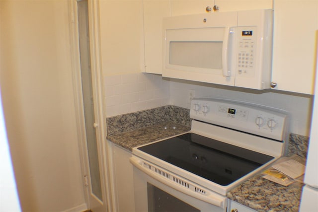 4859 Cedar Springs Rd Unit 147, Dallas, TX 75219 - kitchen with white appliances, stone countertops, white cabinetry, and backsplash
